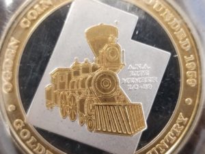 1 Ounce Rount — 2003 — Hill Air Force Base 64 Years – 1939 — Ogden Coin Club Founded 1959 — Golden Spike Country — “A. N. A. Life Member LC-59” (in very small print on the coin)