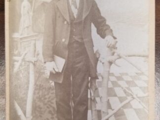 2.5" x 4" --- Small Cabinet Card of a Man Standing by a Bed --- H. Krause's Photographic Studio, La Cour Street (Near Post Office) Pioche, Nev