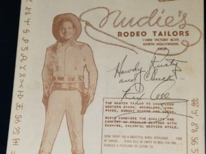 Rex Allen — Inscribed and Signed Advertisement for Nudie’s Rodeo Tailors