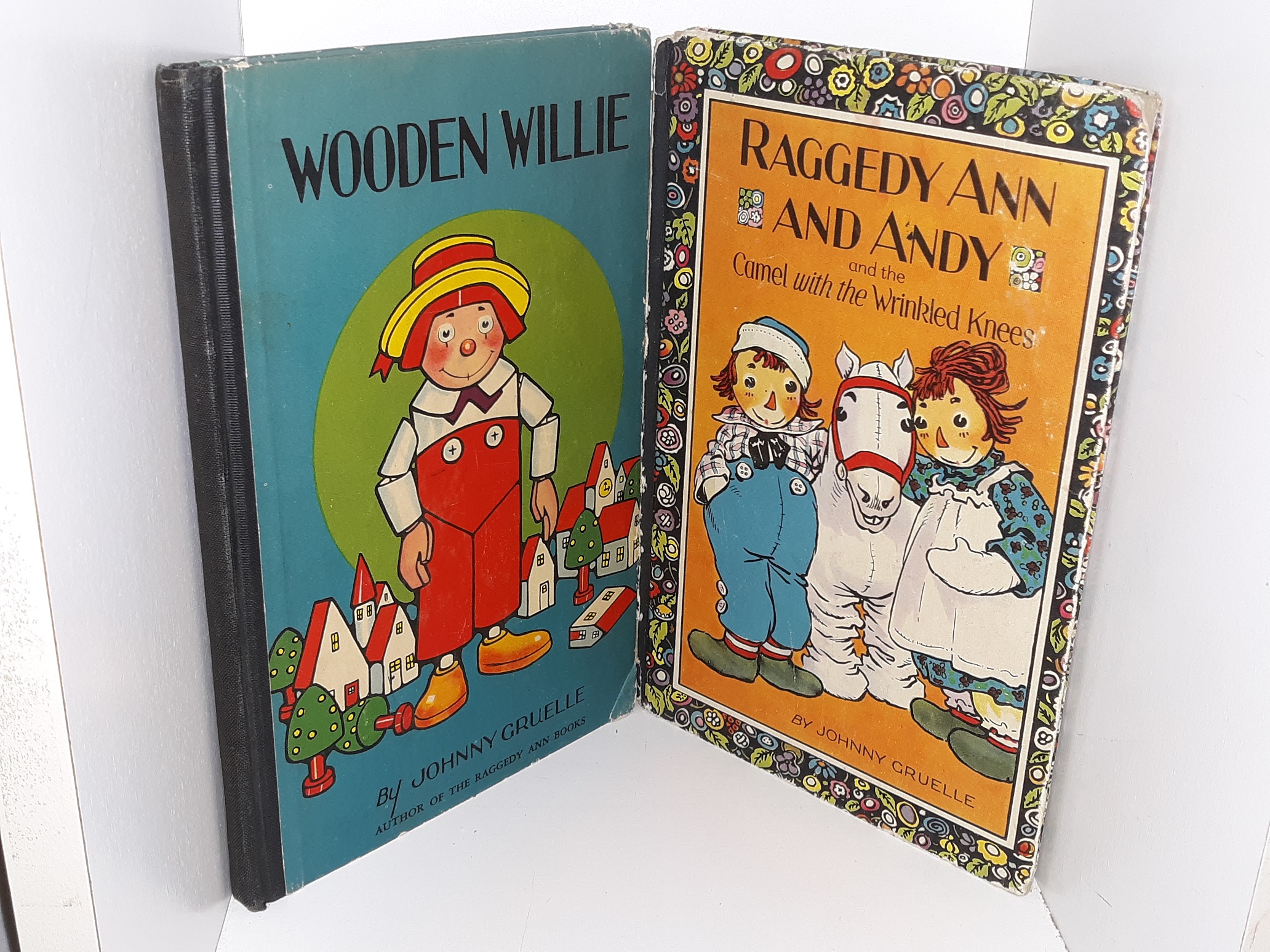 2 Childrens Books: Wooden Willie / Raggedy Ann and Andy and the Camel with the Wrinkled Knees (See Details)