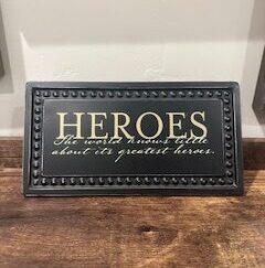 Sign ~ “Heroes, The world knows little about its greatest heroes.” (10 in x 5.25 in)