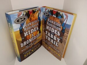 2 Signed Books by Rod Miller: Rawhide Robinson Rides a Dromedary: The True Tale of a Wild West Camel Caballero / Rawhide Robinson Rides the Tabby Trail: The True Tale of a Wild West Catastrophe (See Details)