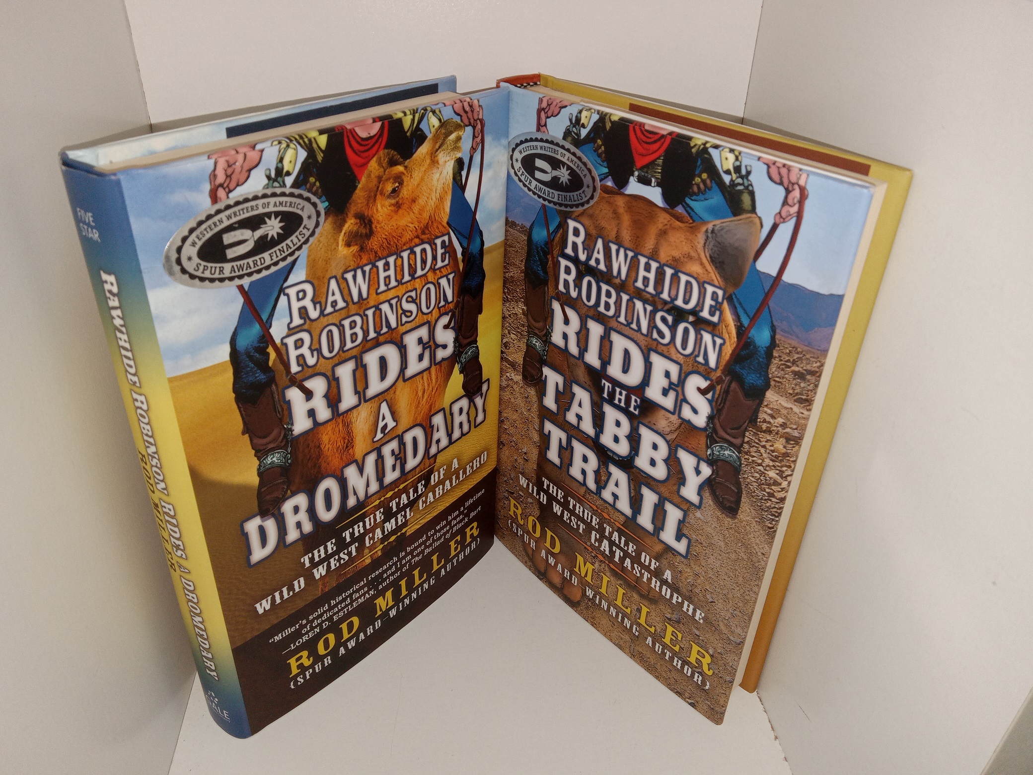 2 Signed Books by Rod Miller: Rawhide Robinson Rides a Dromedary: The True Tale of a Wild West Camel Caballero / Rawhide Robinson Rides the Tabby Trail: The True Tale of a Wild West Catastrophe (See Details)