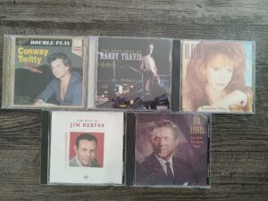 5 Misc. Music CDs by Artists Such as Conway Twitty, Randy Travis, Reba, and Jim Reeves