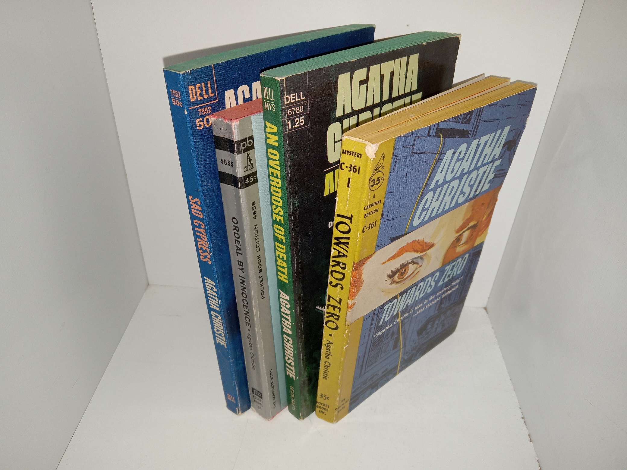 4 Paperback Novels by Agatha Christie: Sad Cypress: A Hercule Poirot Mystery / Ordeal by Innocence / An Overdoese of Death / Towards Zero (See Details)